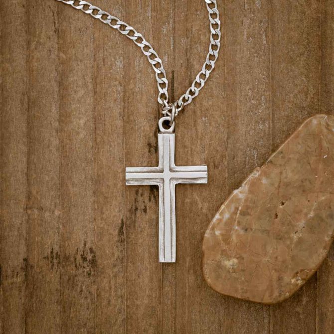 pewter Adopted Cross Necklace, on wood background