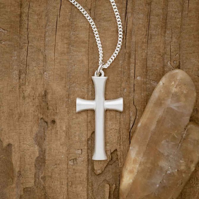 sterling silver Faith Through Love Cross Necklace, on wood background