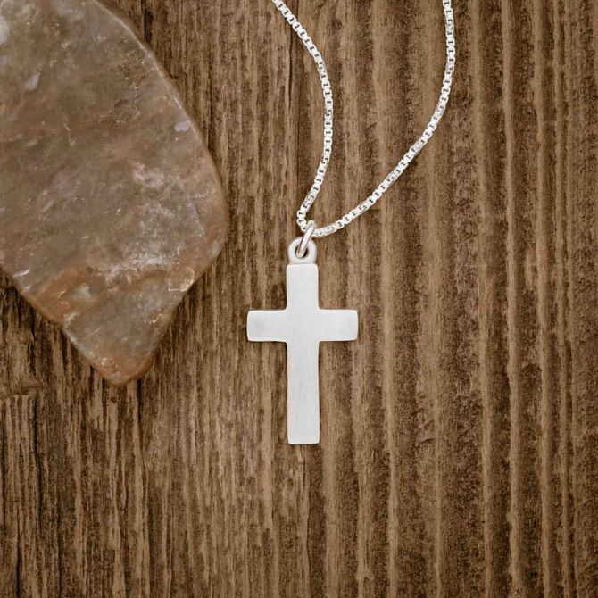 sterling silver Rooted and Grounded Cross necklace, on wood background