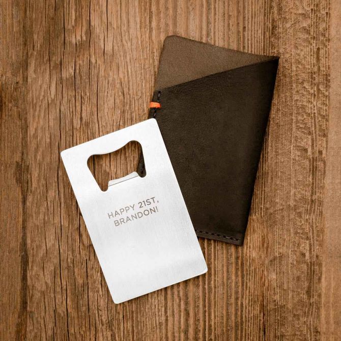 Personalized Trailblazer Bottle Opener and Leather Wallet on wood background
