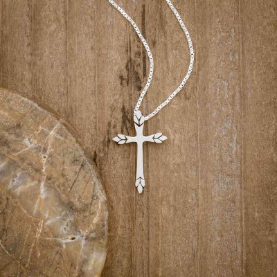 sterling silver Blooming Love Cross necklace, on wood background