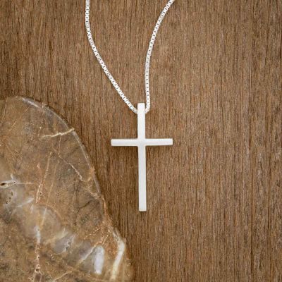 sterling silver child of faith cross necklace, on wood background