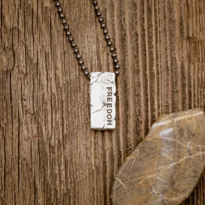 Word of the Year necklace handcrafted in textured, antiqued sterling silver, strung on choice of chain, and personalized with a hand-stamped name, word or date