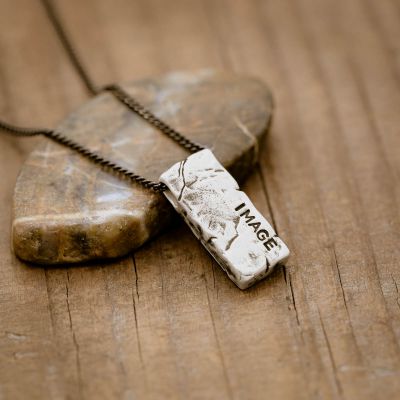 Word of the Year necklace handcrafted in textured, antiqued sterling silver, strung on choice of chain, and personalized with a hand-stamped name, word or date