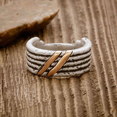 Seven Ring, handcrafted in sterling silver, on a wood background